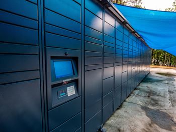 a row of blue storage lockers with a blue tarp above them